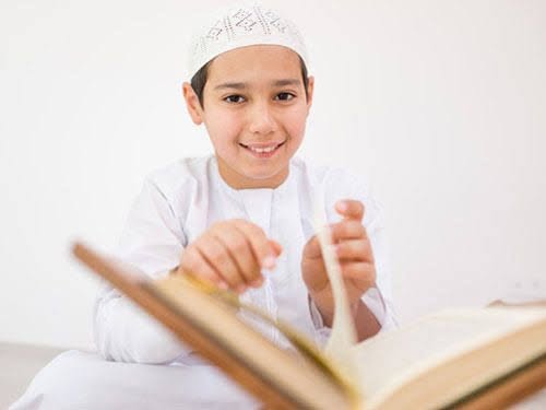 Young student reading Quran